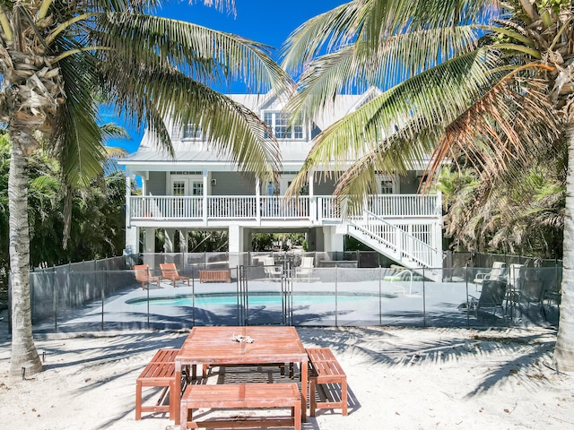 exterior space with fence, stairway, and a fenced in pool