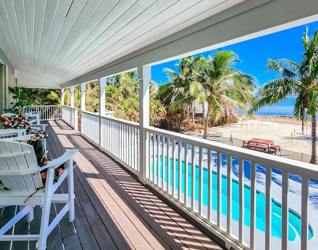 deck featuring an outdoor pool and fence