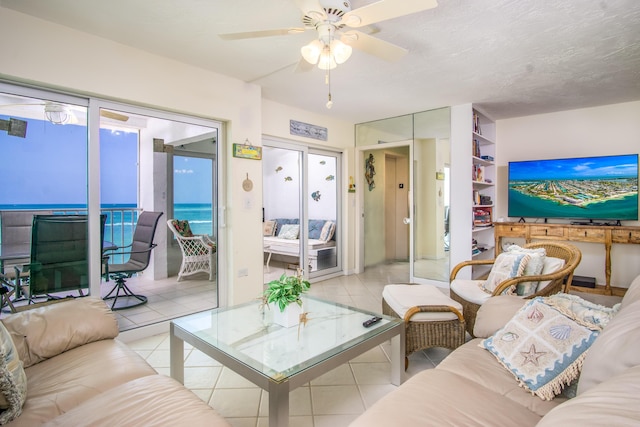 living room featuring light tile patterned flooring and ceiling fan