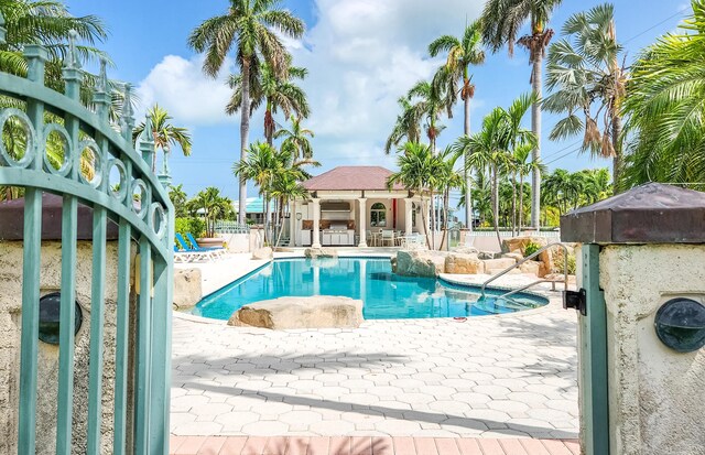 view of swimming pool featuring a fenced in pool, fence, and a patio area