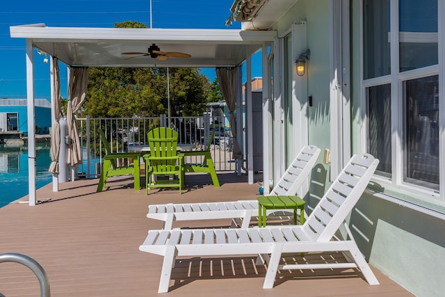 view of patio / terrace with a wooden deck and a ceiling fan