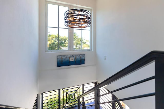staircase featuring a notable chandelier