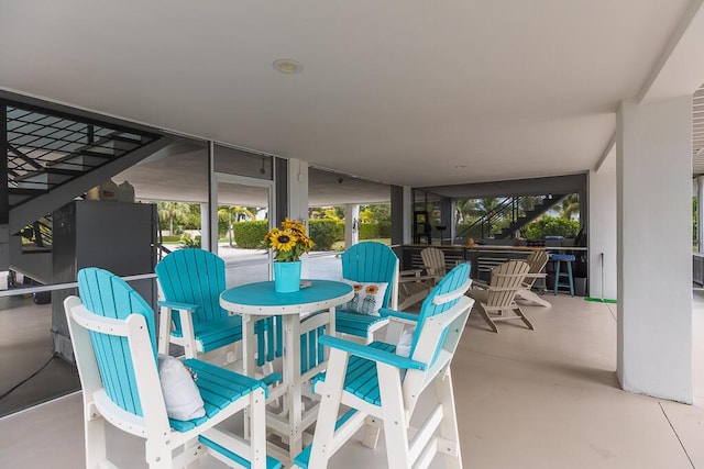 view of patio / terrace featuring stairway and outdoor dining space