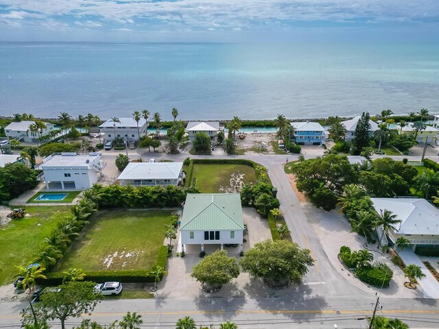 drone / aerial view featuring a water view and a residential view
