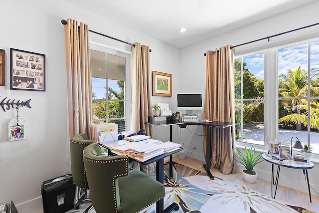 home office with plenty of natural light and wood finished floors