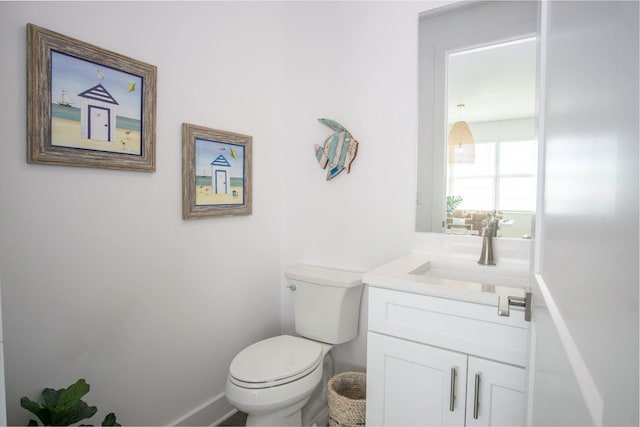 half bathroom featuring toilet and vanity