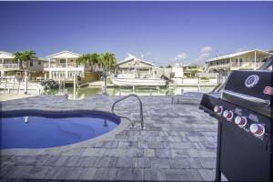 pool featuring a patio and a grill