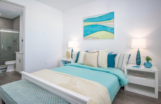 bedroom with ensuite bath and wood finished floors