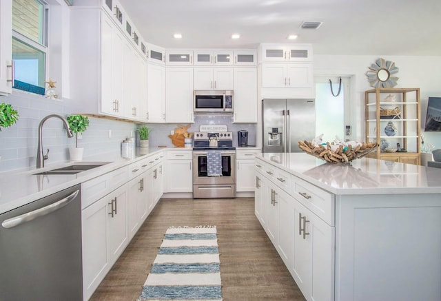 kitchen featuring dark wood-style floors, visible vents, appliances with stainless steel finishes, and a sink