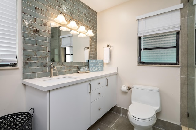 full bath featuring a shower with door, tasteful backsplash, vanity, tile patterned flooring, and toilet