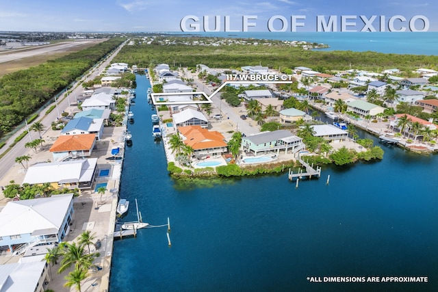 drone / aerial view featuring a water view and a residential view