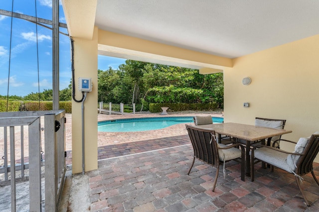 pool with a patio and outdoor dining area