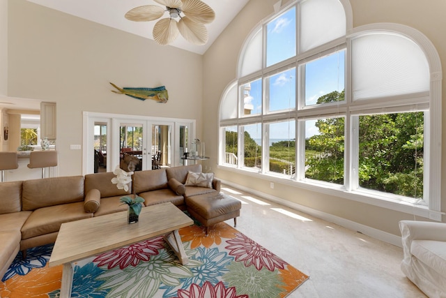 living area featuring high vaulted ceiling, french doors, baseboards, and ceiling fan