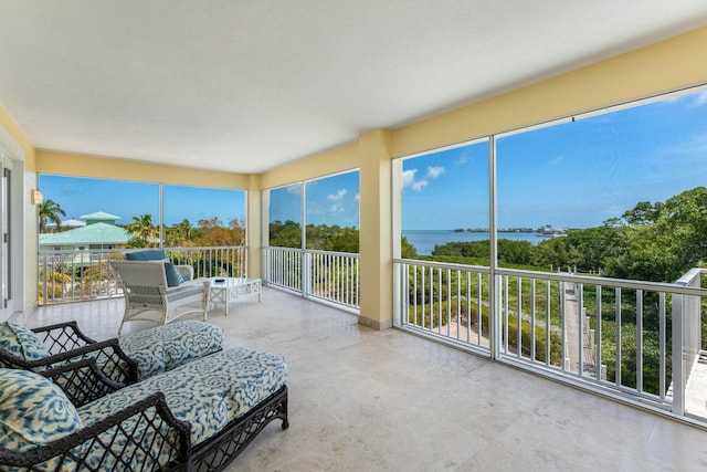 sunroom with plenty of natural light and a water view