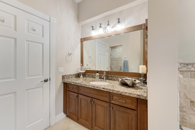 bathroom with tile patterned floors, vanity, and tiled shower