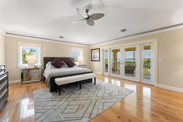 bedroom with light wood-style floors, visible vents, access to outside, and vaulted ceiling