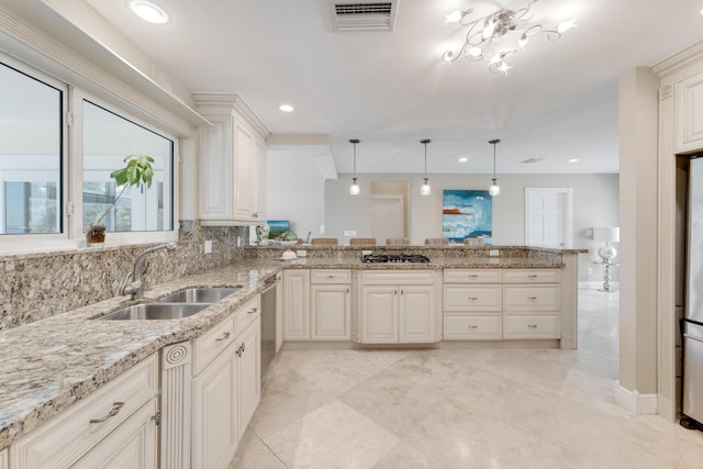kitchen with recessed lighting, a peninsula, visible vents, appliances with stainless steel finishes, and a sink
