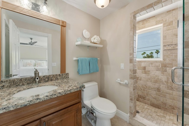 full bath featuring toilet, vanity, a ceiling fan, and a stall shower