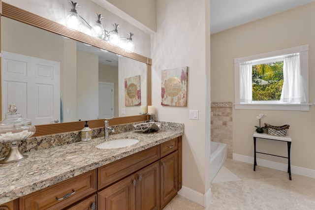 full bathroom featuring tile patterned flooring, vanity, baseboards, and a washtub