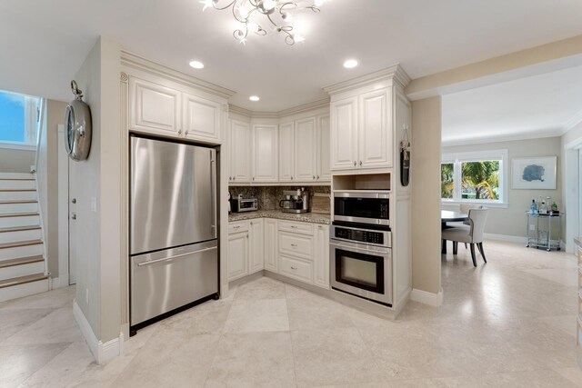 kitchen featuring tasteful backsplash, baseboards, recessed lighting, stainless steel appliances, and light stone counters