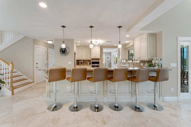 kitchen with decorative backsplash, recessed lighting, and light stone counters