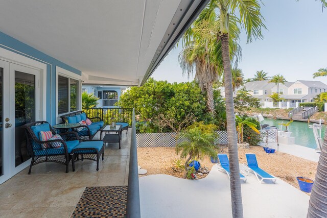 view of patio with an outdoor hangout area, a fenced backyard, and a water view