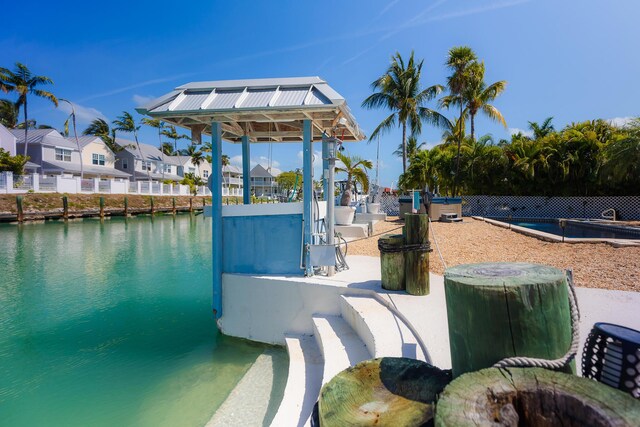 dock area with a water view and a residential view