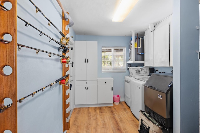 laundry area with washer and clothes dryer, cabinet space, and light wood finished floors