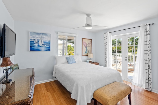 bedroom featuring access to exterior, baseboards, light wood-style floors, and a ceiling fan