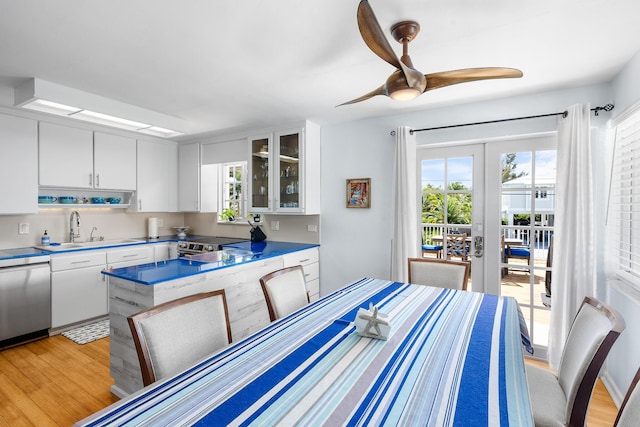 dining area featuring french doors, light wood-style floors, and a healthy amount of sunlight