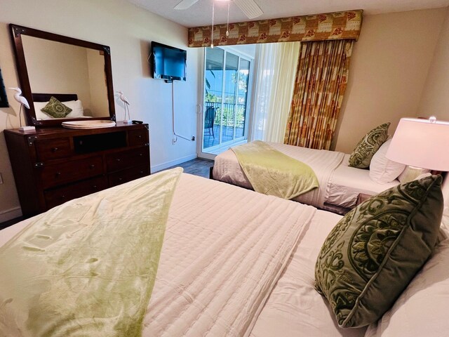 bedroom featuring baseboards, a ceiling fan, and access to exterior