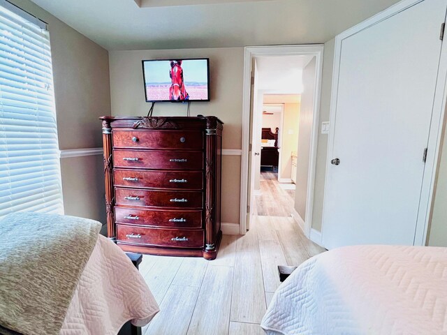 bedroom featuring light wood-type flooring and baseboards