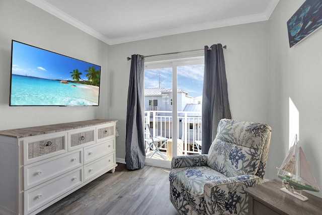 sitting room featuring wood finished floors and crown molding