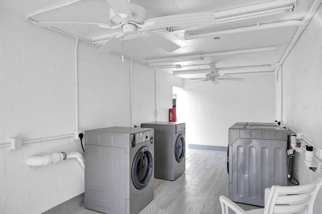 laundry area featuring ceiling fan, laundry area, separate washer and dryer, and light wood finished floors