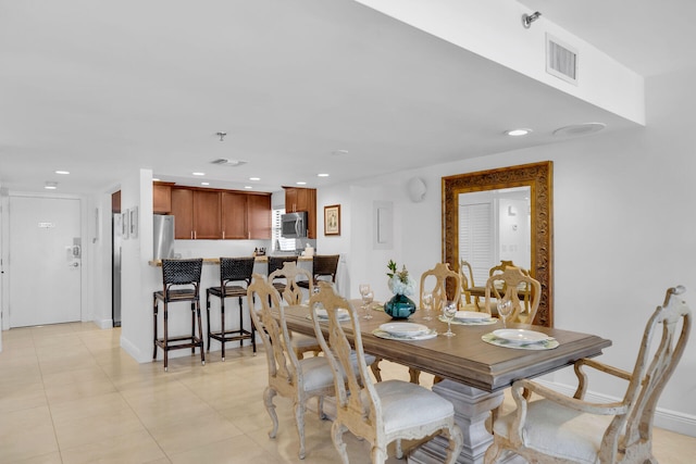 dining area with baseboards, light tile patterned floors, visible vents, and recessed lighting