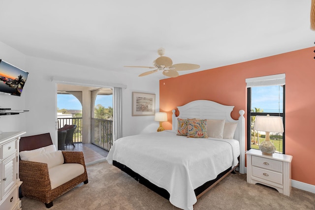 bedroom with light carpet, access to outside, and multiple windows