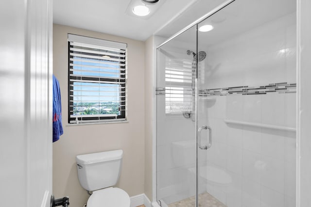 full bathroom featuring toilet and a stall shower