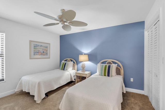 carpeted bedroom featuring a closet, a ceiling fan, and baseboards