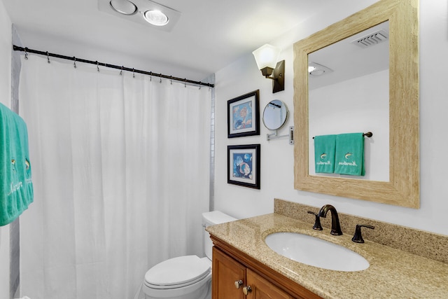 full bathroom with toilet, visible vents, and vanity