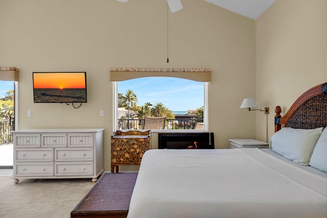 bedroom with lofted ceiling, access to exterior, and carpet