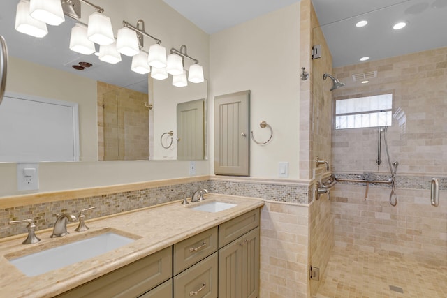 full bathroom with double vanity, a shower stall, and a sink