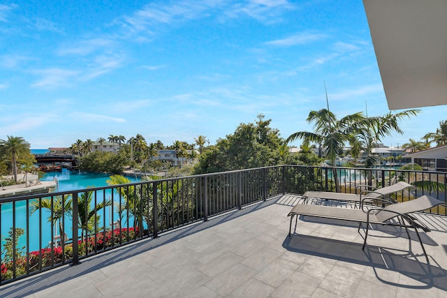 view of patio / terrace featuring a water view and a balcony