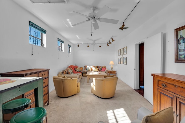 carpeted living area with a ceiling fan, rail lighting, and visible vents