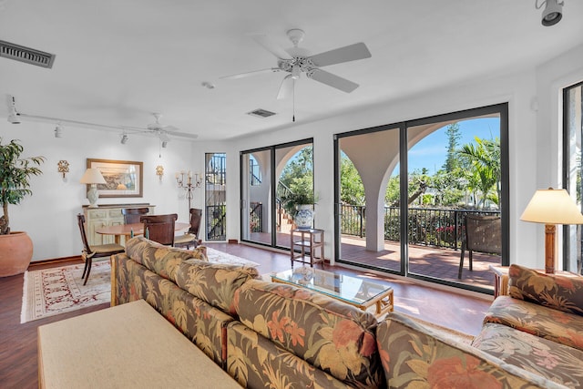 living room with rail lighting, visible vents, ceiling fan, and wood finished floors