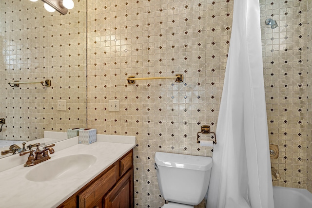 bathroom with shower / tub combo with curtain, tile walls, toilet, and vanity