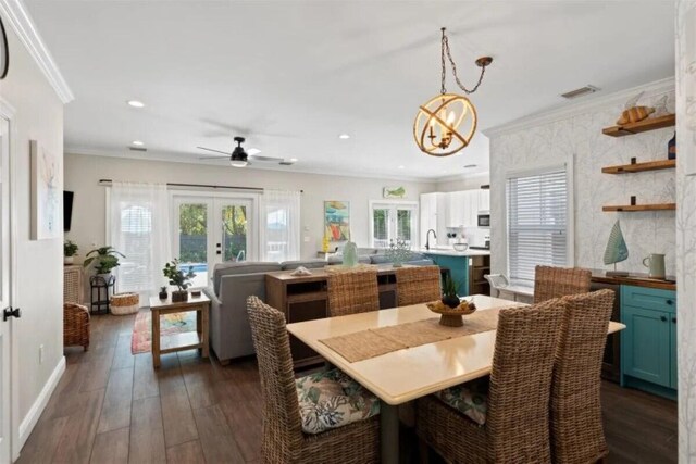 7202 Simran Ln, Duck, FL 33050 - dining room with crown molding, dark wood-style flooring, french doors, ceiling fan, and recessed lighting