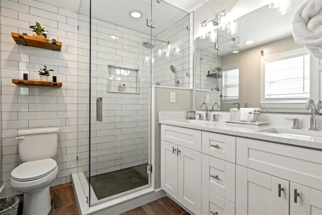 7202 Simran Ln, Duck, FL 33050 - bathroom featuring a shower stall, double vanity, wood finished floors, and recessed lighting