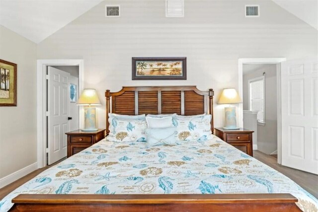 7202 Simran Ln, Duck, FL 33050 - bedroom featuring lofted ceiling and wood finished floors