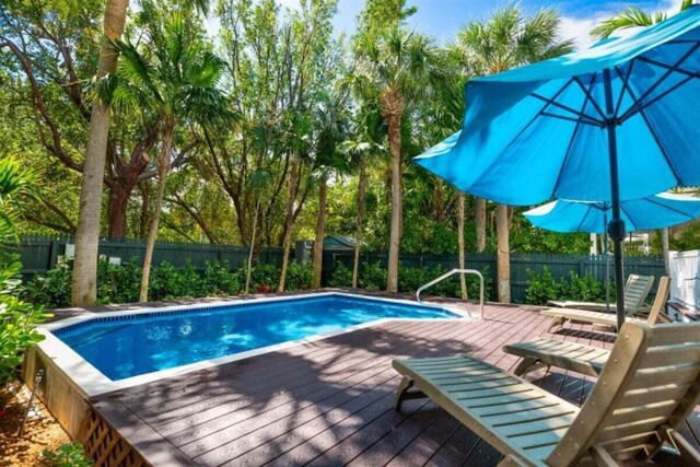 7202 Simran Ln, Duck, FL 33050 - view of swimming pool featuring a fenced backyard and a wooden deck