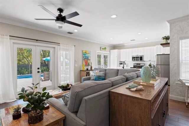 7202 Simran Ln, Duck, FL 33050 - living room featuring french doors, wood finished floors, crown molding, ceiling fan, and recessed lighting